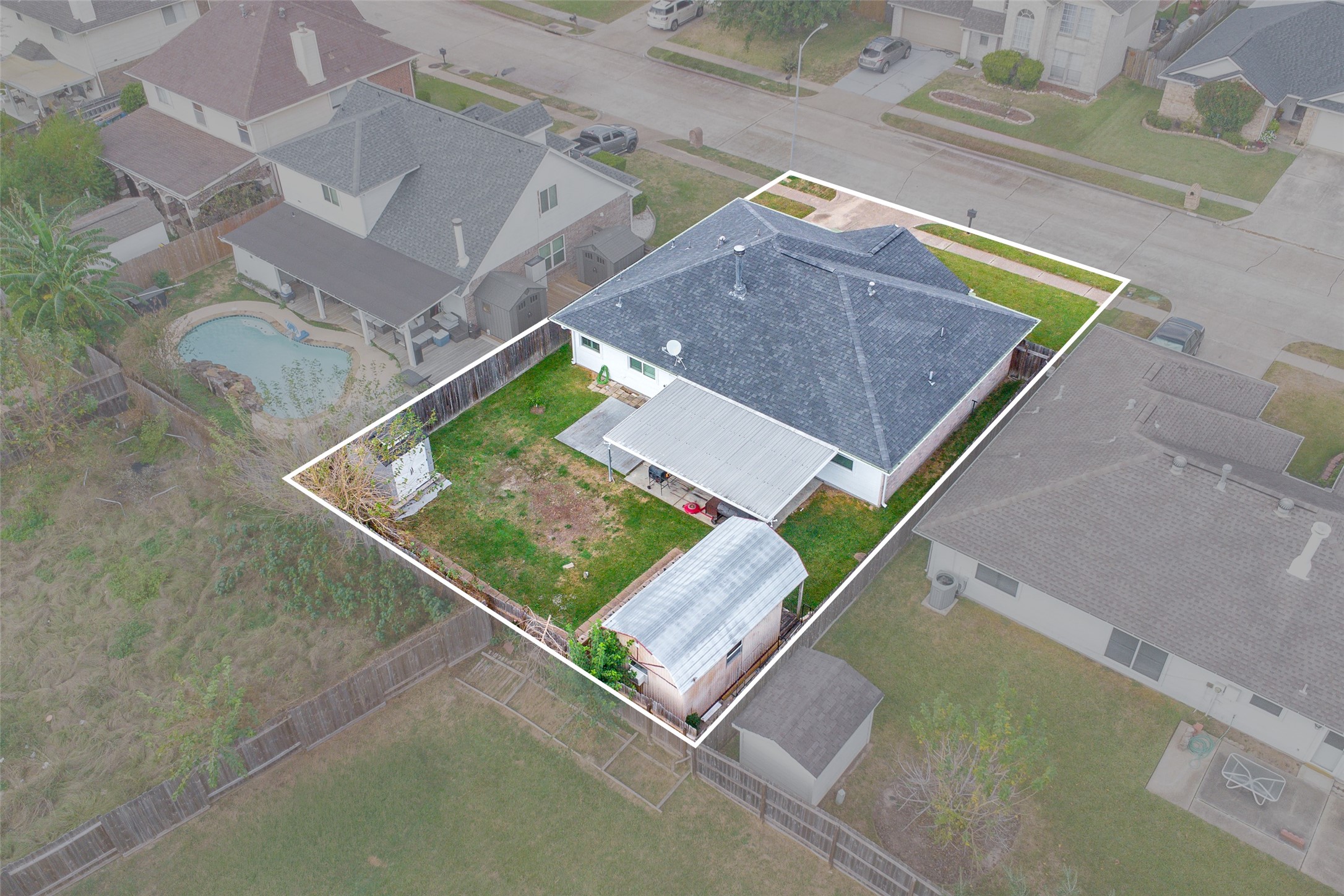 4826 Stonebridge Street Baytown, TX 77521 - Photo 17 of 18 This aerial view highlights the spacious, fully fenced backyard, showcasing the ample outdoor space and privacy the property offers.