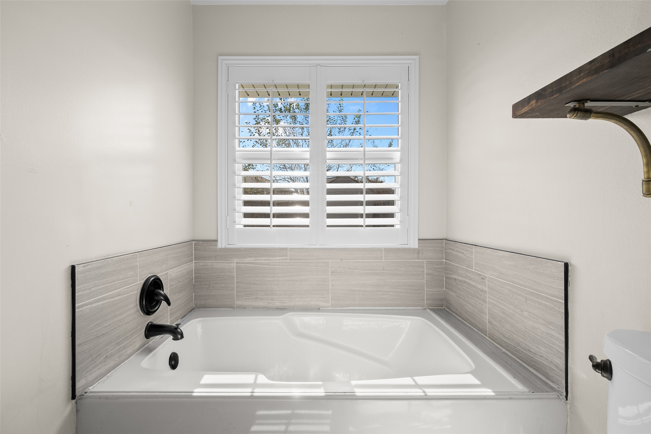 4826 Stonebridge Street Baytown, TX 77521 - Photo 6 of 18 Indulge in the primary bathroom with a luxurious soaking tub, creating a modern spa-like retreat right at home.