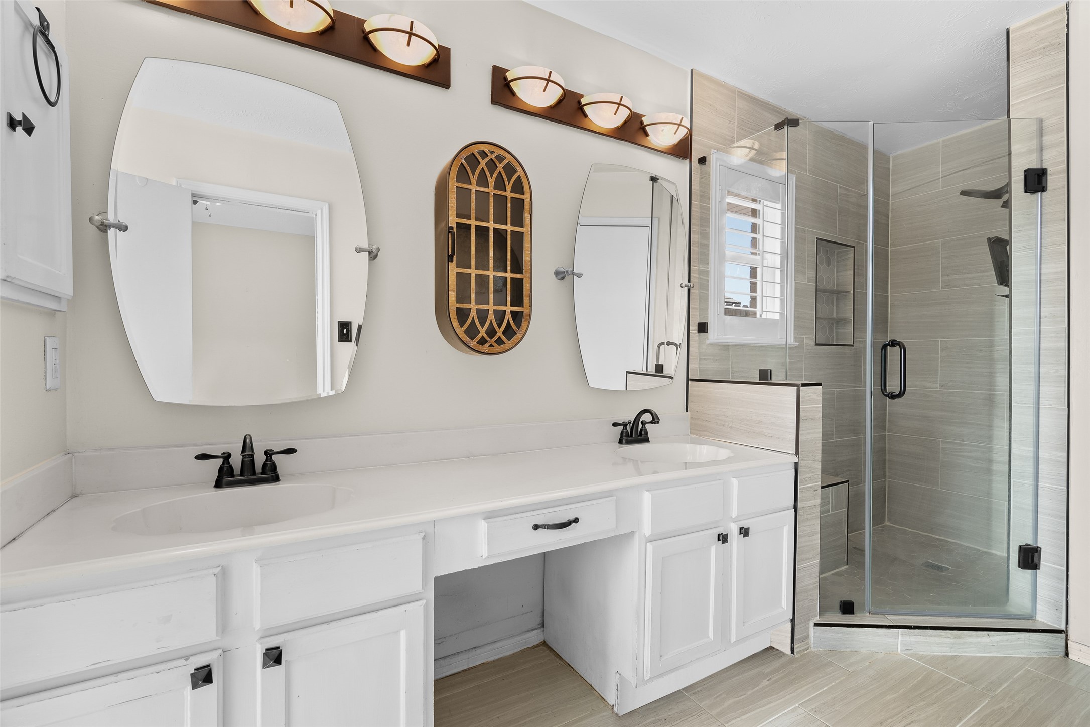 4826 Stonebridge Street Baytown, TX 77521 - Photo 7 of 18 The primary bathroom also showcases a spacious tiled walk-in shower and a double sink vanity, combining modern design with everyday luxury for a sleek and refreshing retreat.