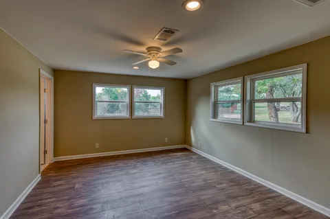 a view of a livingroom with a ceiling fan and window