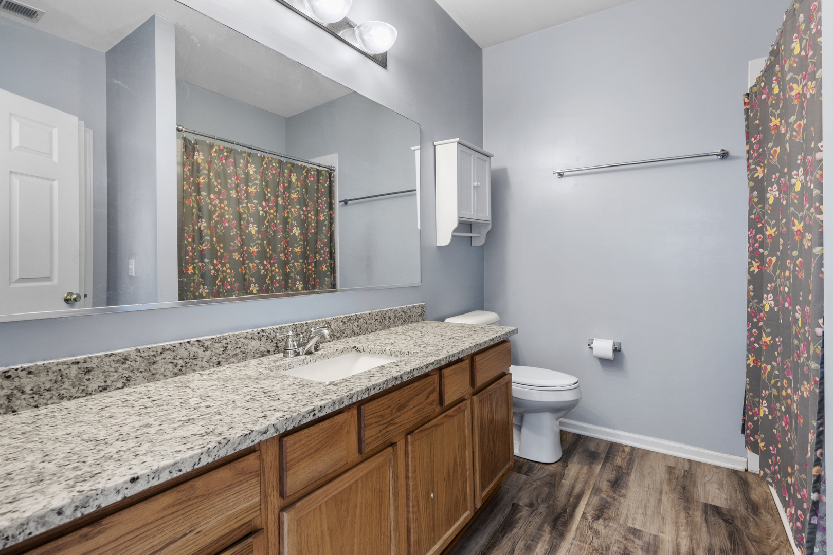 24011 Pear Tree Circle Plainfield, IL 60585 - Photo 14 of 31 a bathroom with a granite countertop sink a toilet a mirror and shower