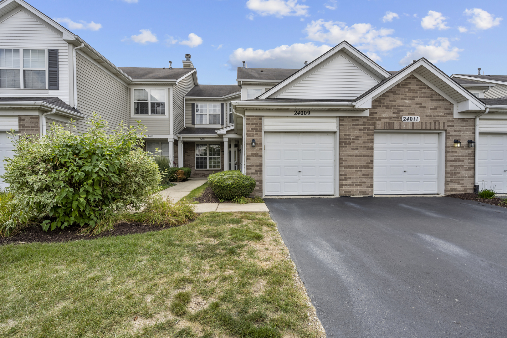 24011 Pear Tree Circle Plainfield, IL 60585 - Photo 27 of 31 a front view of a house with a yard and garage