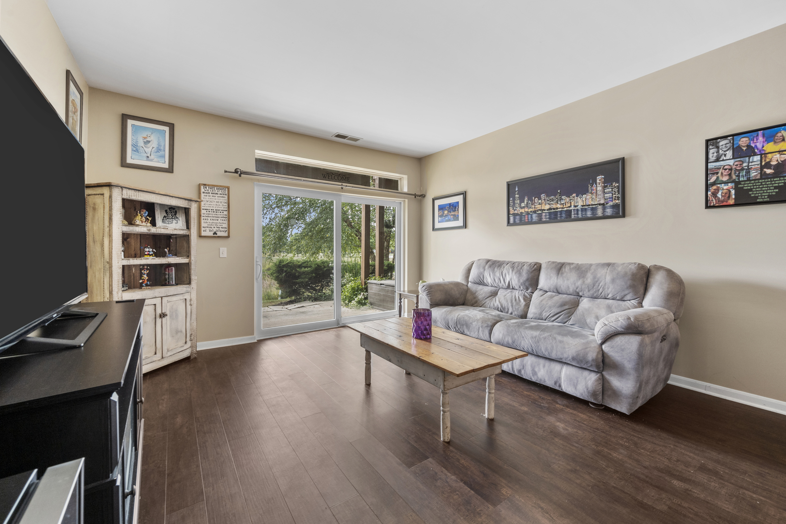 24011 Pear Tree Circle Plainfield, IL 60585 - Photo 6 of 31 a living room with furniture and a flat screen tv