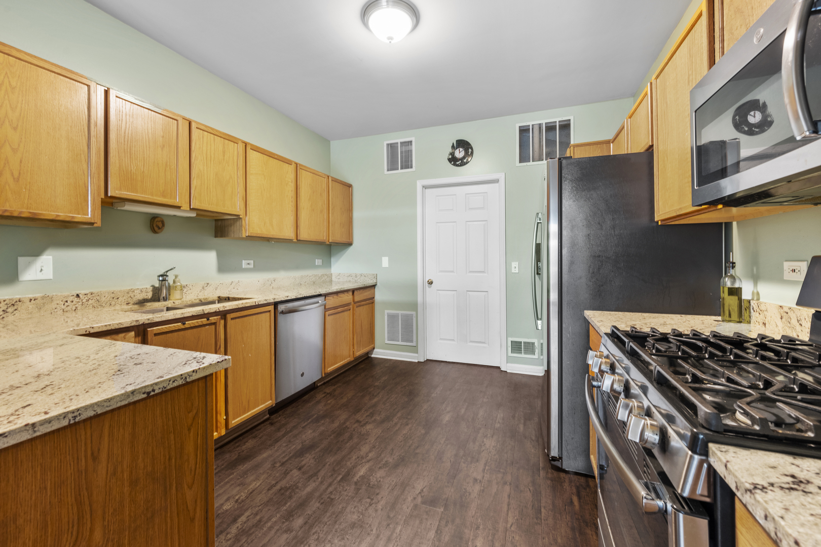 24011 Pear Tree Circle Plainfield, IL 60585 - Photo 9 of 31 a kitchen with stainless steel appliances granite countertop a stove a sink dishwasher and a refrigerator