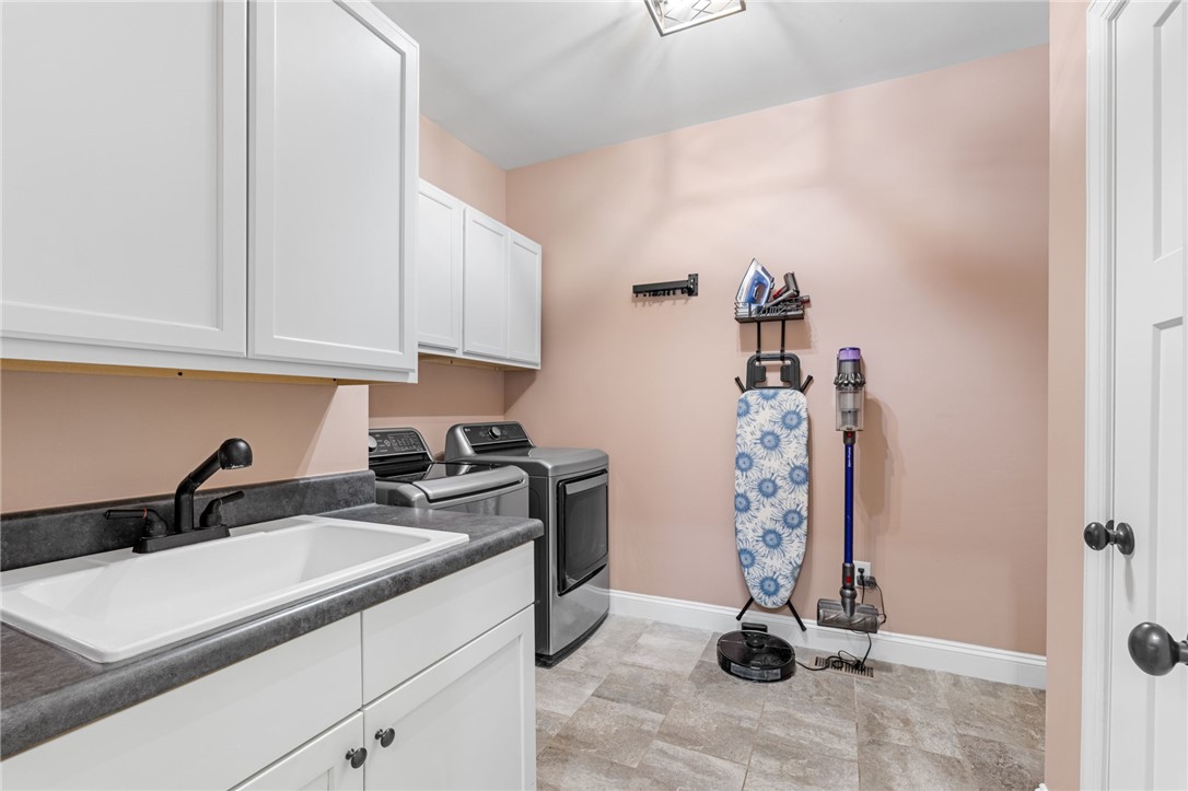 10 Colonel Storrs Court Greer, SC 29650 - Photo 22 of 48 Enjoy a sink in the laundry room, many cabinets and a closet to store the extras.