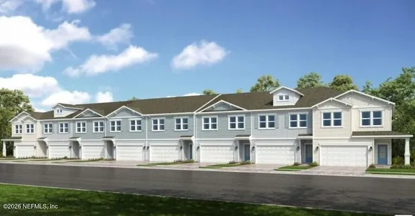 a view of a big house with a big yard and large trees