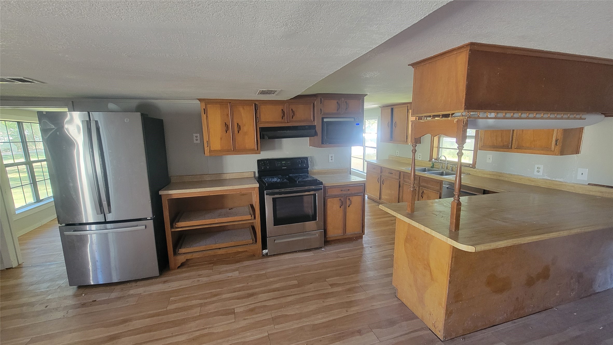 2960 Call Street Vidor, TX 77662 - Photo 12 of 46 a kitchen with granite countertop a refrigerator and a stove top oven