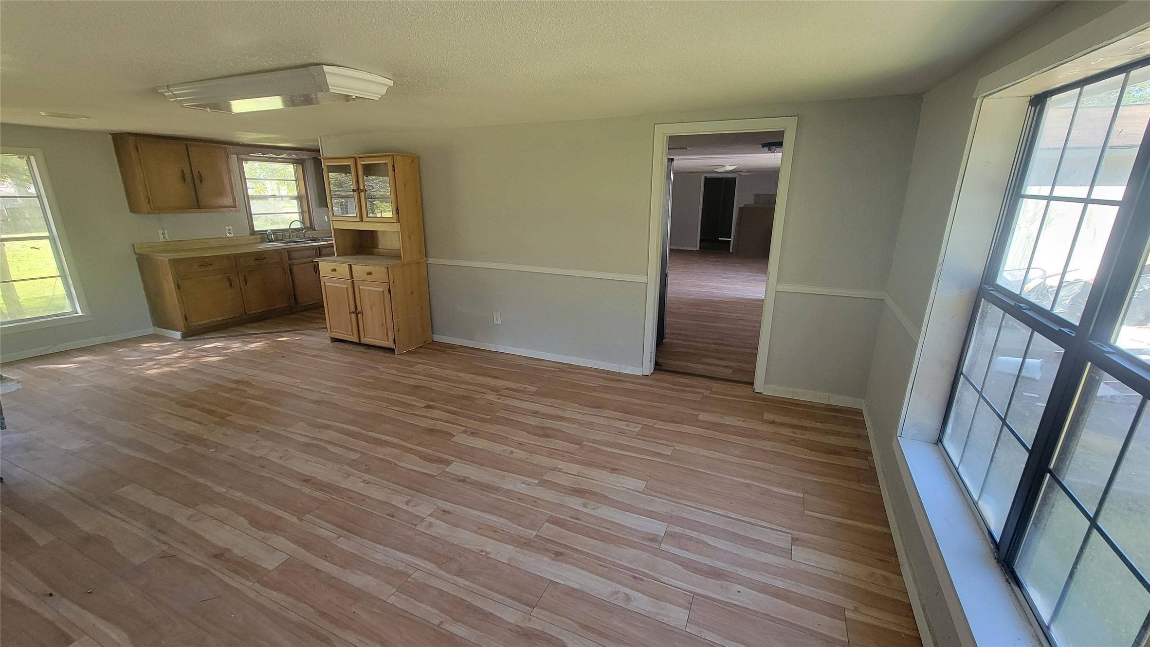 2960 Call Street Vidor, TX 77662 - Photo 14 of 46 an empty room with wooden floor and a kitchen