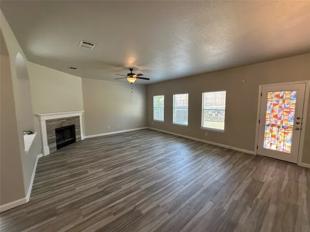 wooden floor in an empty room with a window