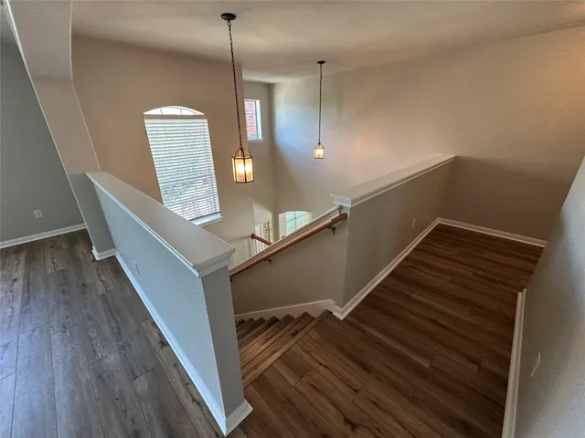 a view of entryway and hall with wooden floor