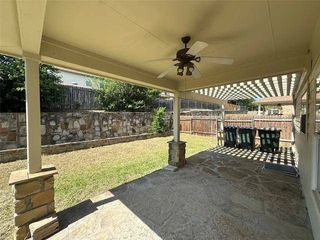 a view of a porch with a table and chairs