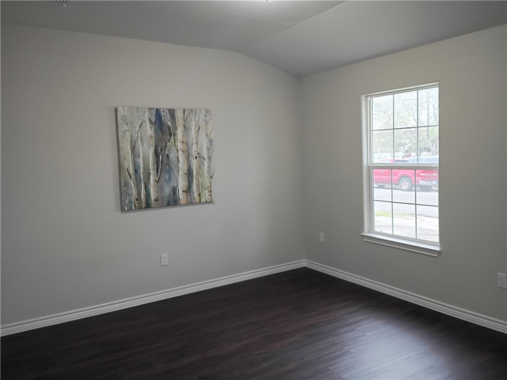 1652 16th Street Corpus Christi, TX 78404 - Photo 3 of 19 an empty room with wooden floor and windows