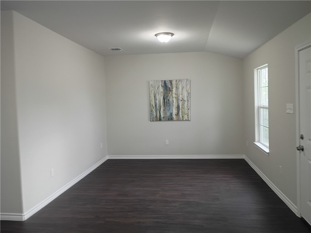 1652 16th Street Corpus Christi, TX 78404 - Photo 4 of 19 wooden floor in an empty room with a window