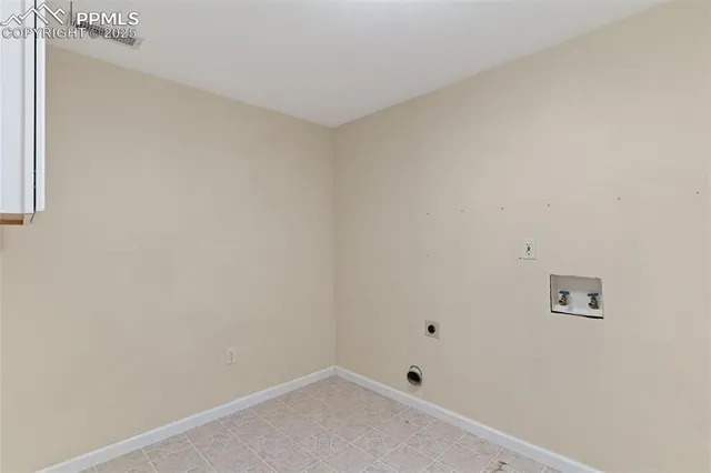 a small space with a white wall and a window