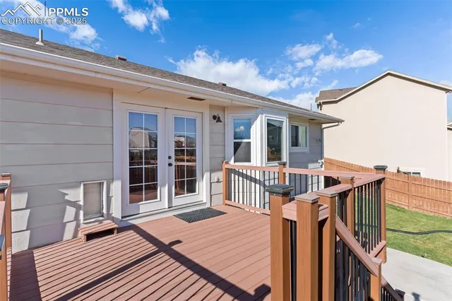 a view of a house with wooden deck