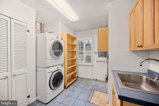 a utility room with sink dryer and washer
