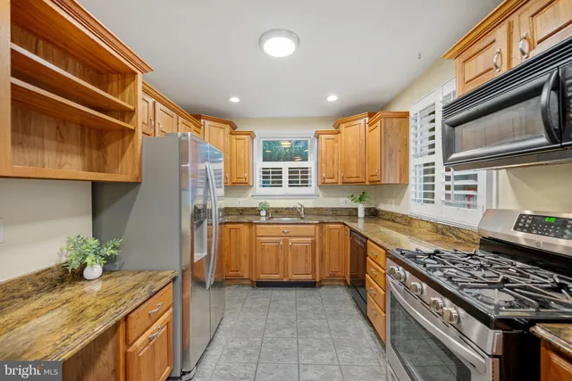 a kitchen with granite countertop stainless steel appliances and counter space