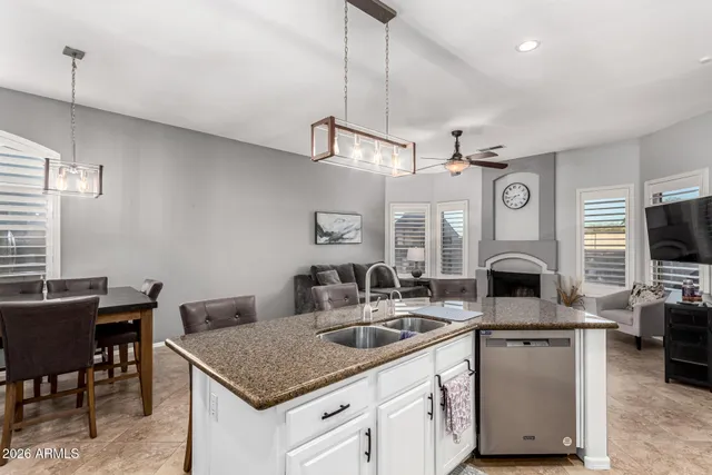 a kitchen with granite countertop a sink cabinets and window