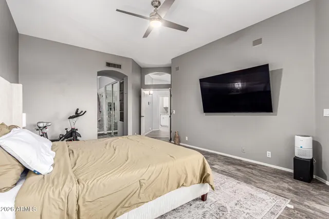 a bedroom with a bed and a flat screen tv