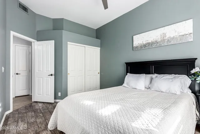 a bedroom with a large bed and a chandelier