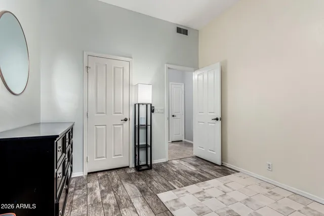 a view of a room with wooden floor and a bathroom