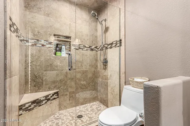 a bathroom with a toilet and a shower