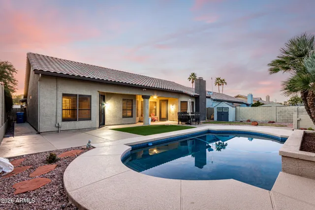 a swimming pool with barbeque oven in front of it