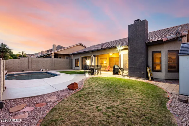 a view of a house with backyard and porch