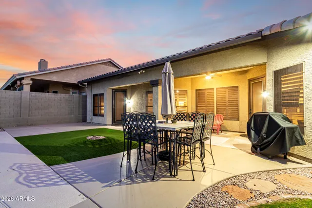 a view of a patio with table and chairs and potted plants