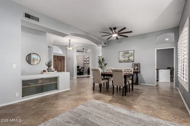 a view of a dining room and a livingroom with furniture a fireplace