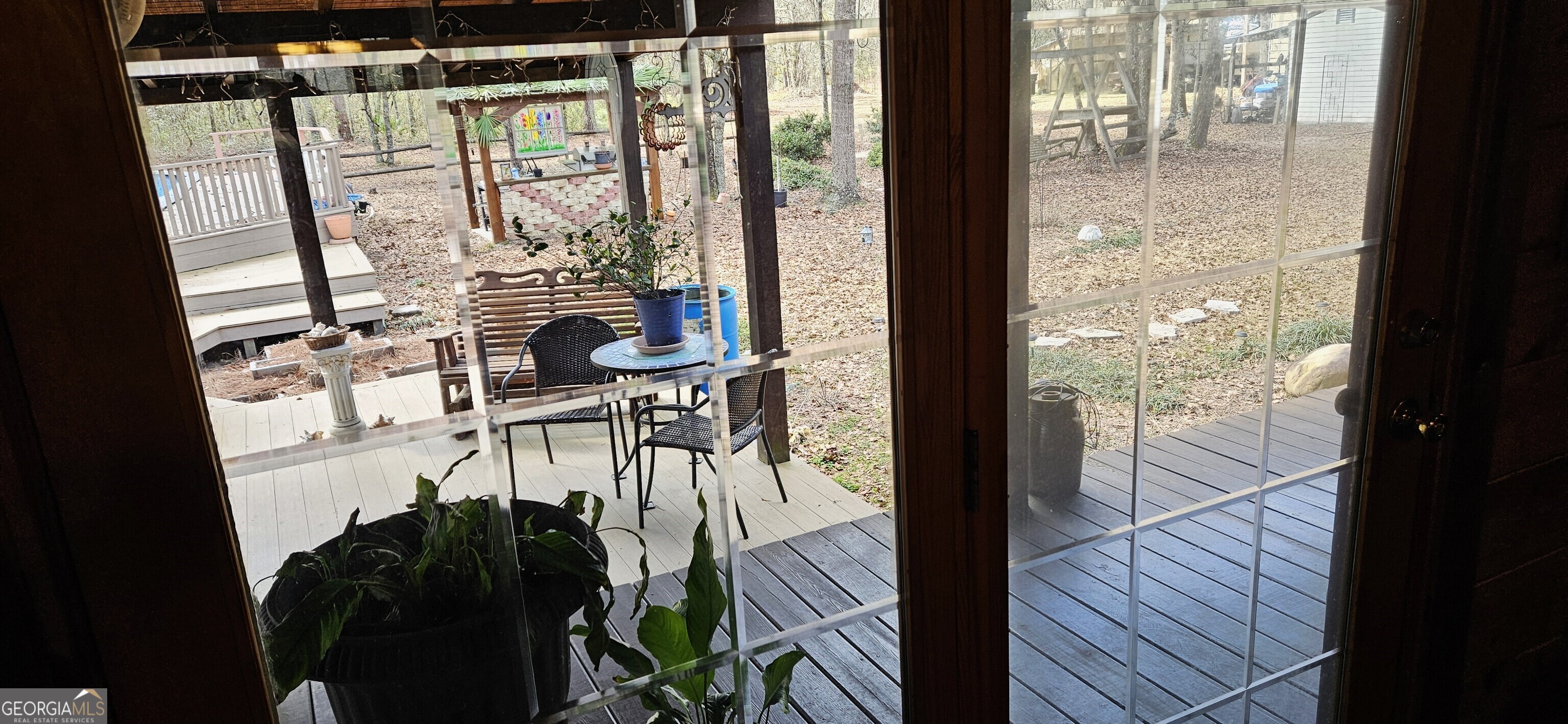 1851-i G I G Lanier Road Pembroke, GA 31321 - Photo 24 of 80 a view of a balcony with chairs and wooden floor
