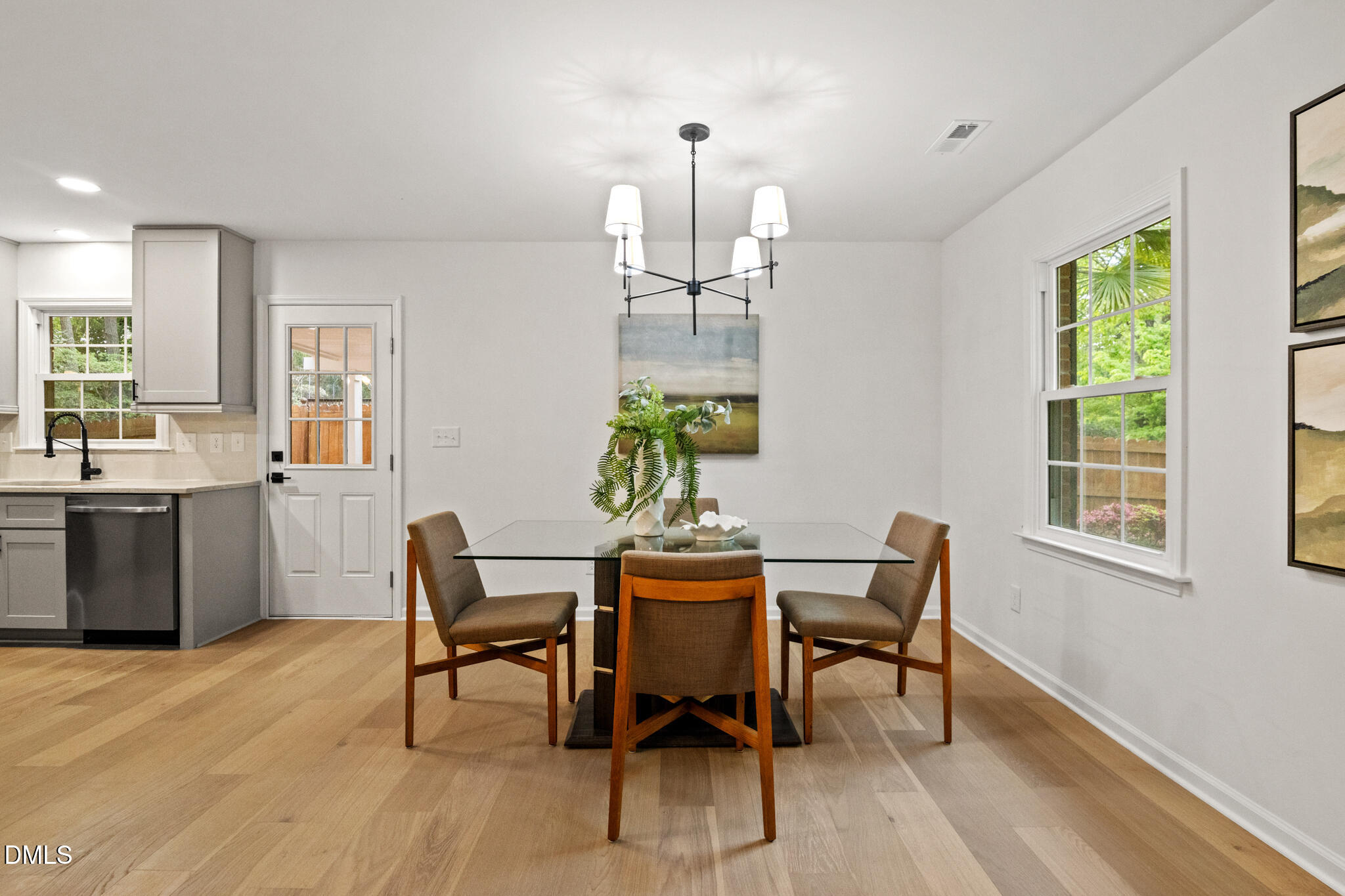 3509 Morningside Drive Raleigh, NC 27607 - Photo 17 of 49 a dining room with furniture a chandelier and wooden floor