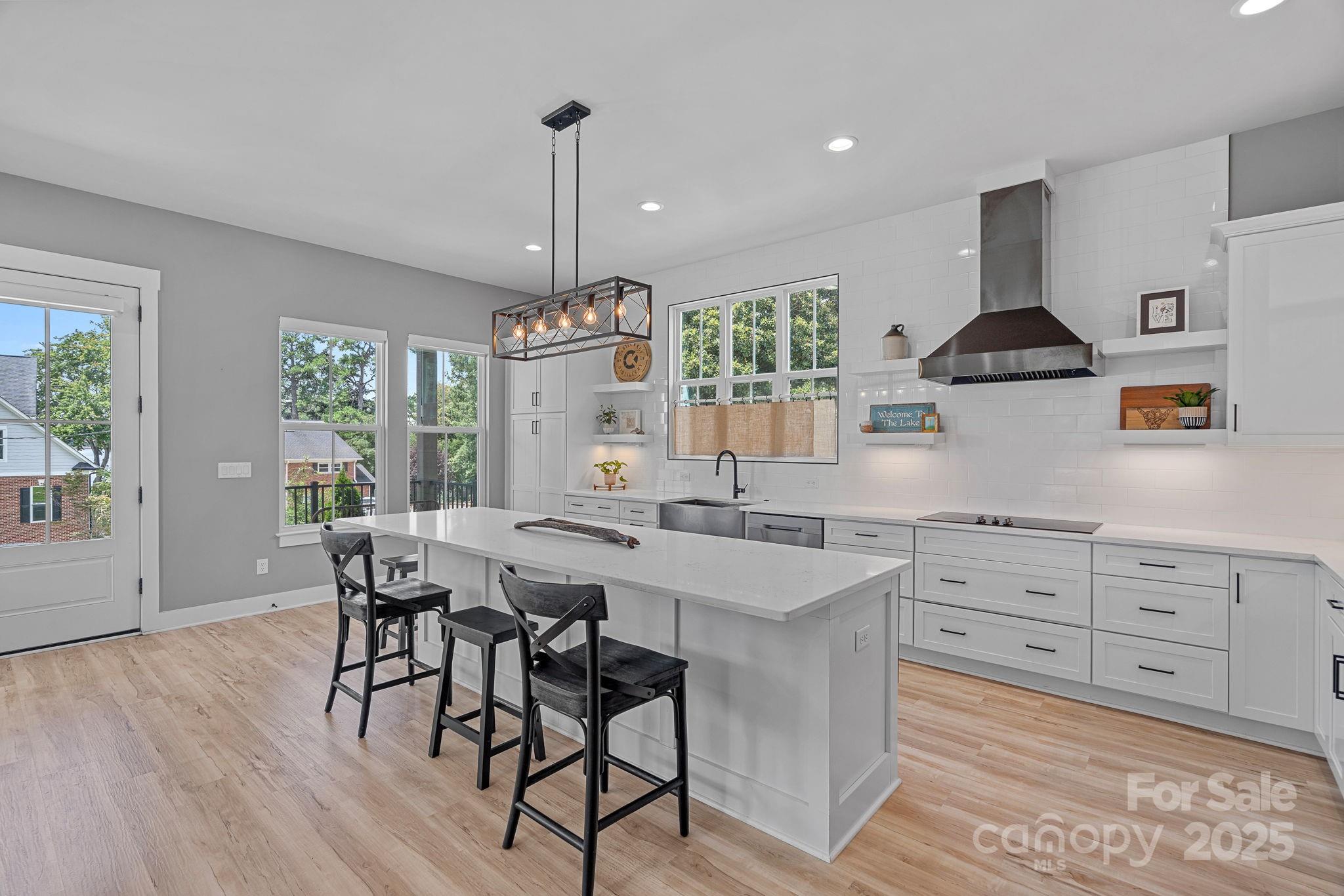 20615 Rio Oro Drive Cornelius, NC 28031 - Photo 11 of 40 a kitchen with granite countertop white cabinets and stainless steel appliances