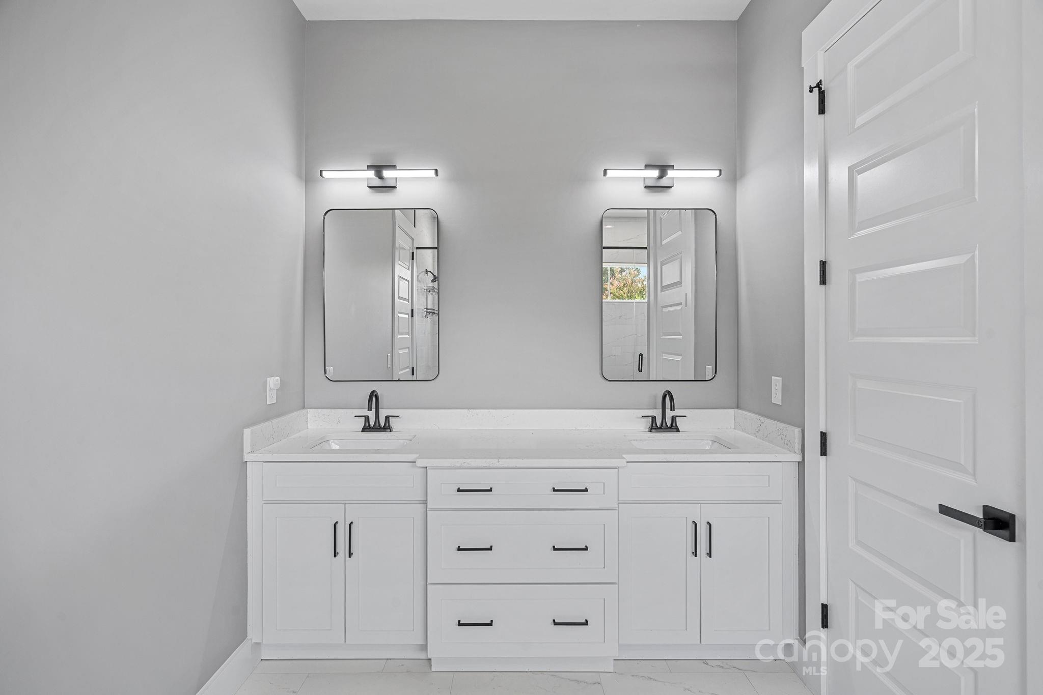 20615 Rio Oro Drive Cornelius, NC 28031 - Photo 19 of 40 a bathroom with double sink and a mirror