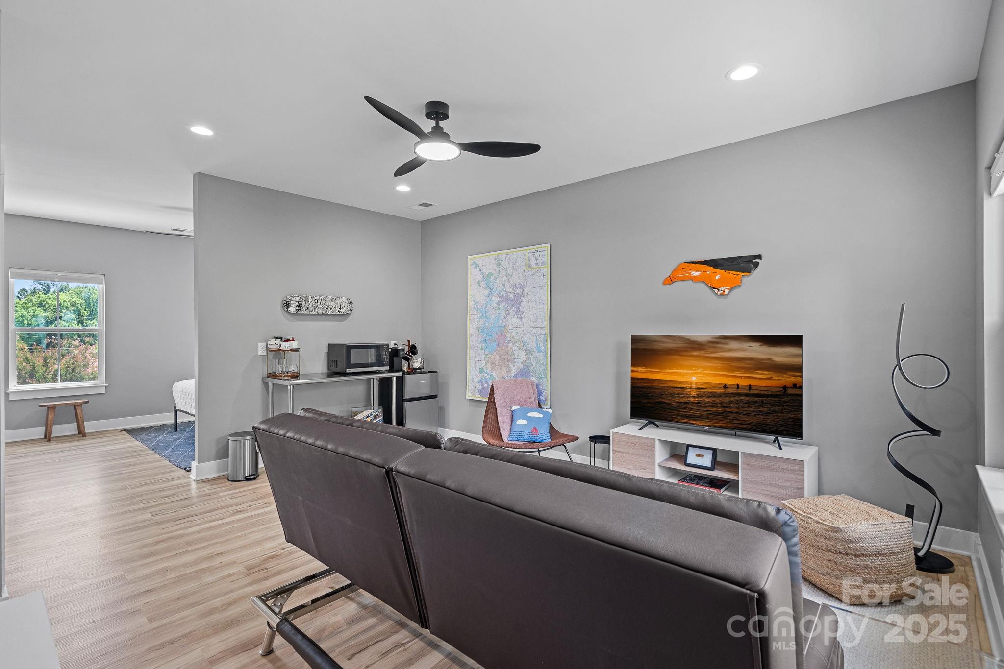 20615 Rio Oro Drive Cornelius, NC 28031 - Photo 31 of 40 a living room with furniture and a flat screen tv