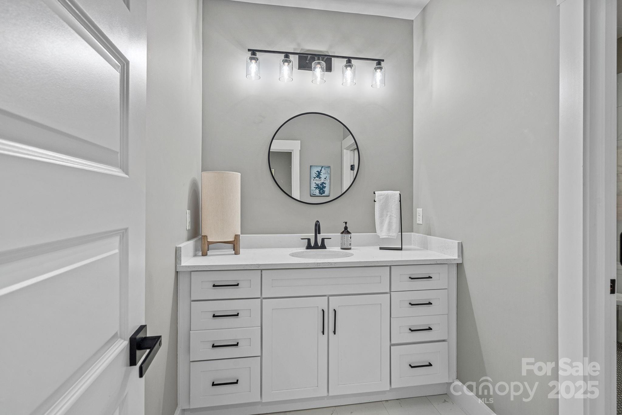 20615 Rio Oro Drive Cornelius, NC 28031 - Photo 34 of 40 a bathroom with a sink and a mirror