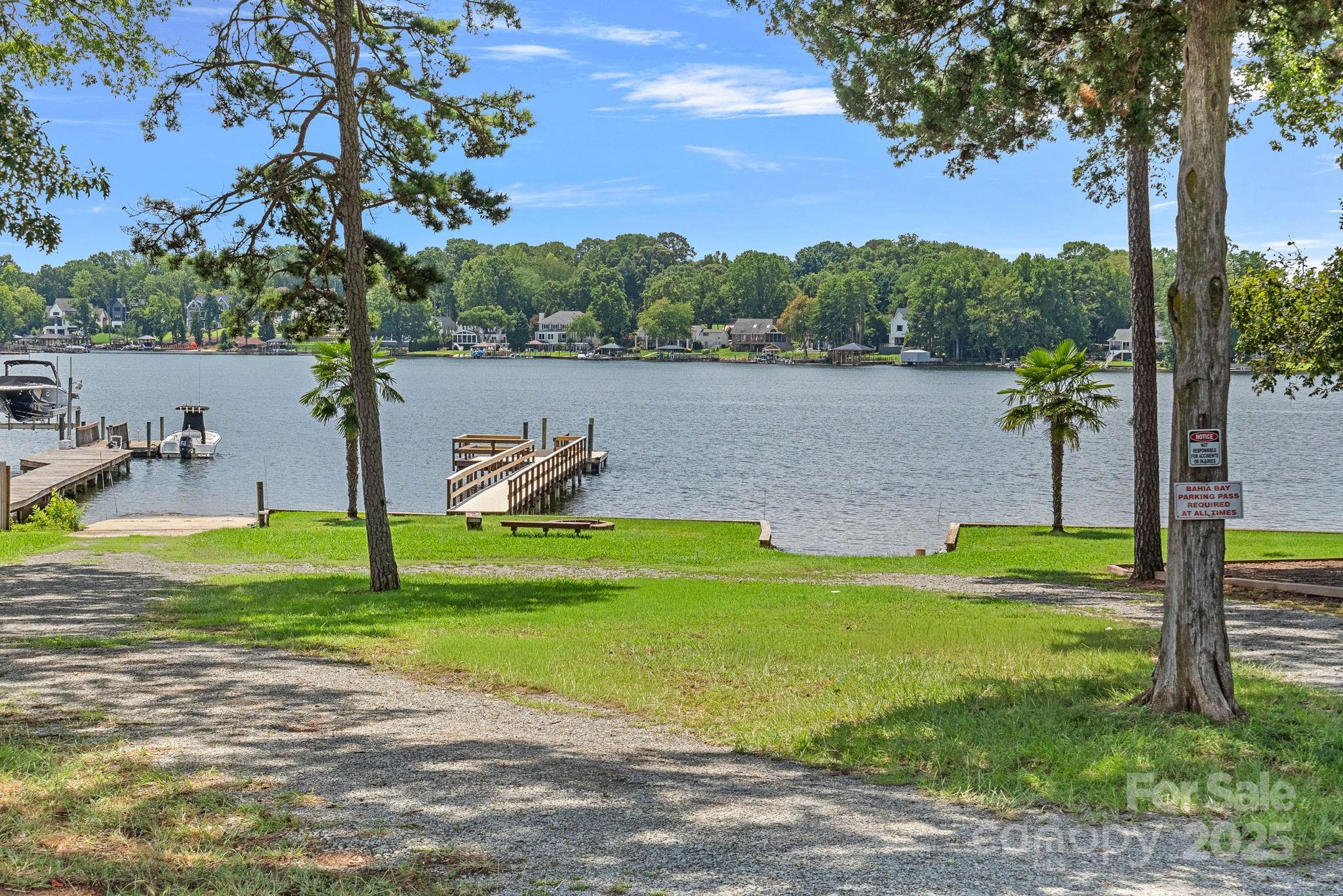 20615 Rio Oro Drive Cornelius, NC 28031 - Photo 39 of 40 a view of a lake with a yard and large trees