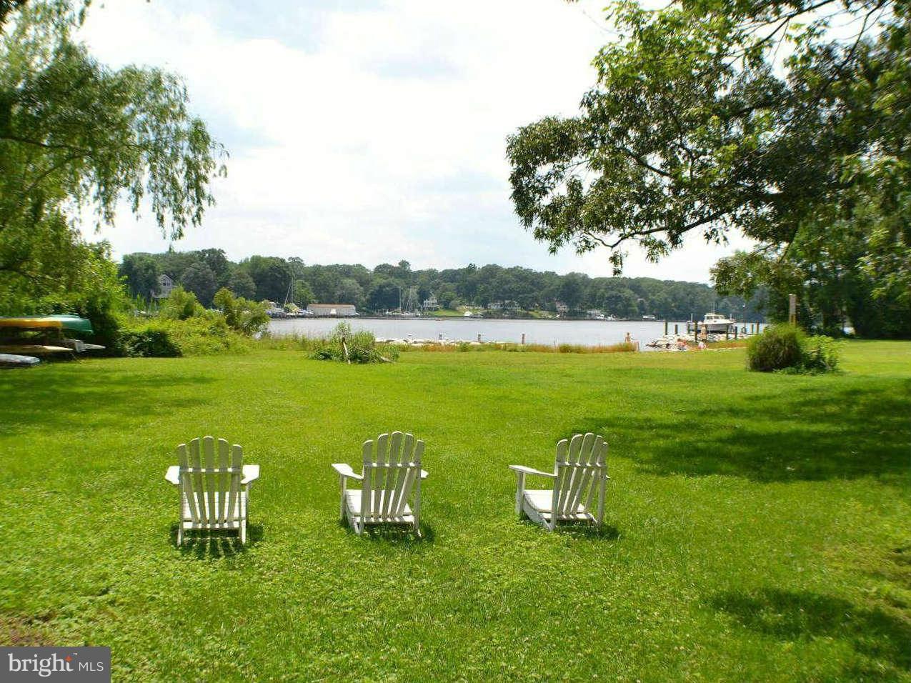 392 Riverside Drive Pasadena, MD 21122 - Photo 1 of 30 a view of a lake with a building in the background