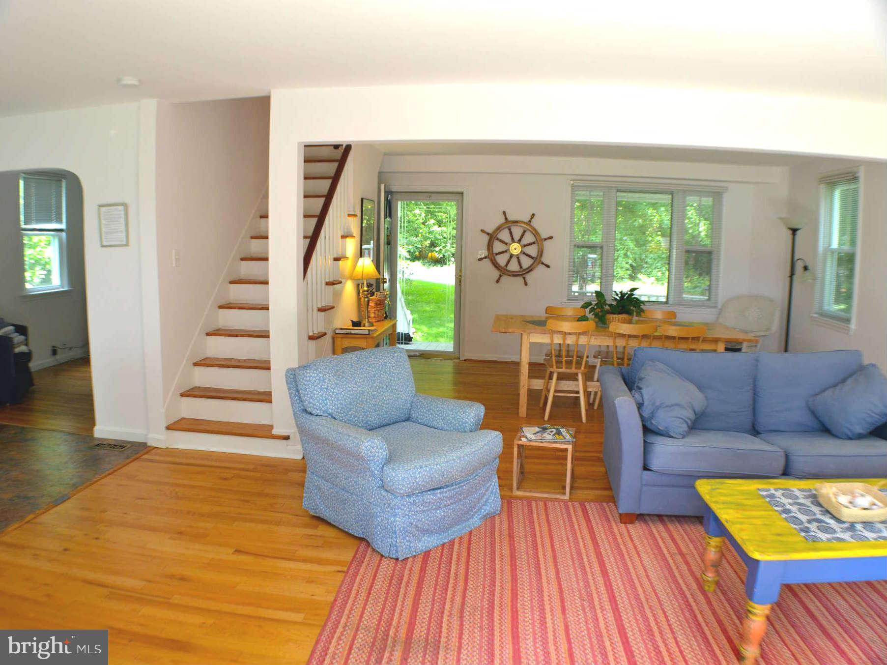 392 Riverside Drive Pasadena, MD 21122 - Photo 26 of 30 a living room with furniture and a dining table with wooden floor