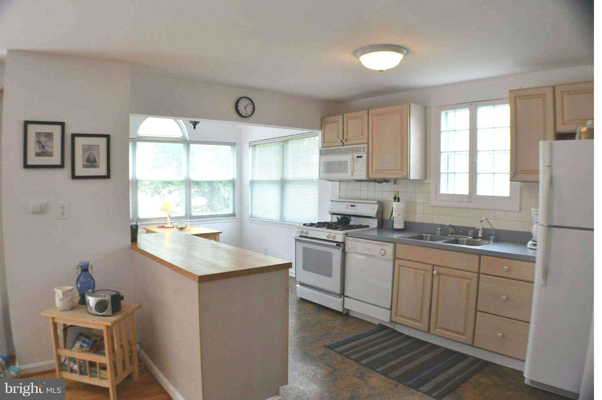 392 Riverside Drive Pasadena, MD 21122 - Photo 7 of 30 a kitchen with granite countertop a sink and a window