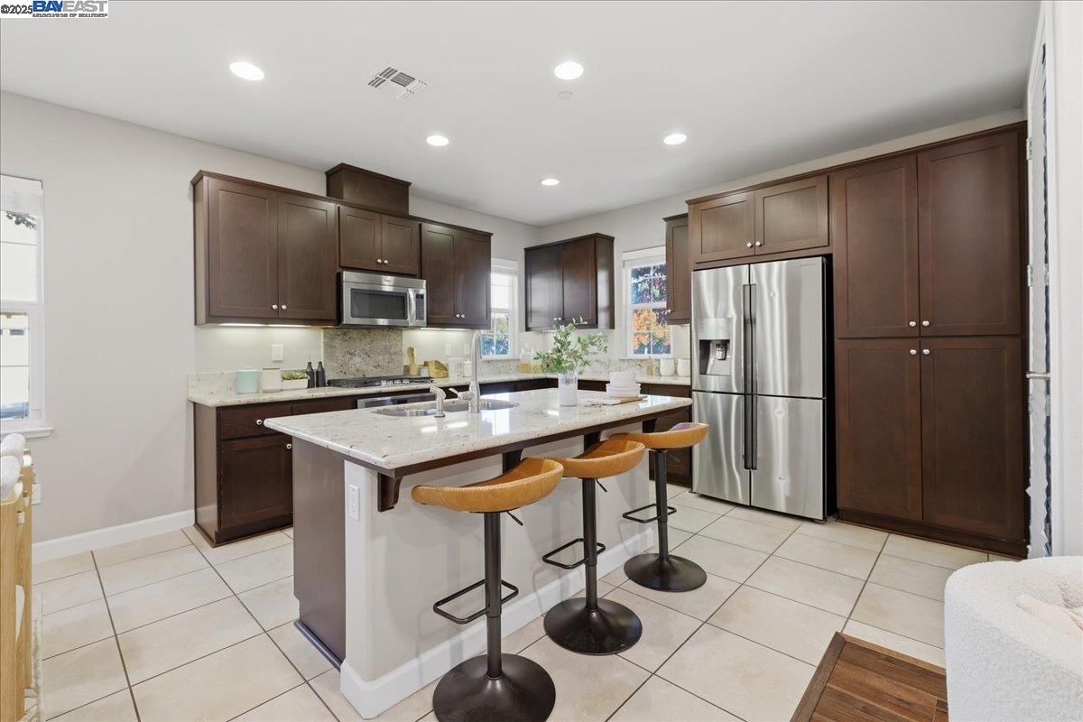 1504 Middle Lane Hayward, CA 94545 - Photo 15 of 60 a kitchen with stainless steel appliances granite countertop a refrigerator and a stove top oven
