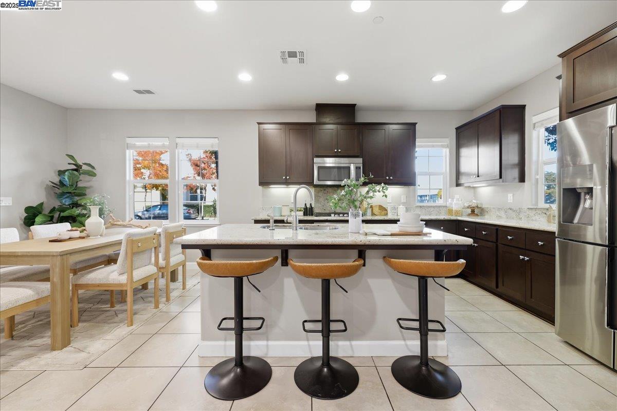 1504 Middle Lane Hayward, CA 94545 - Photo 21 of 60 a kitchen with stainless steel appliances kitchen island granite countertop a table chairs sink and cabinets