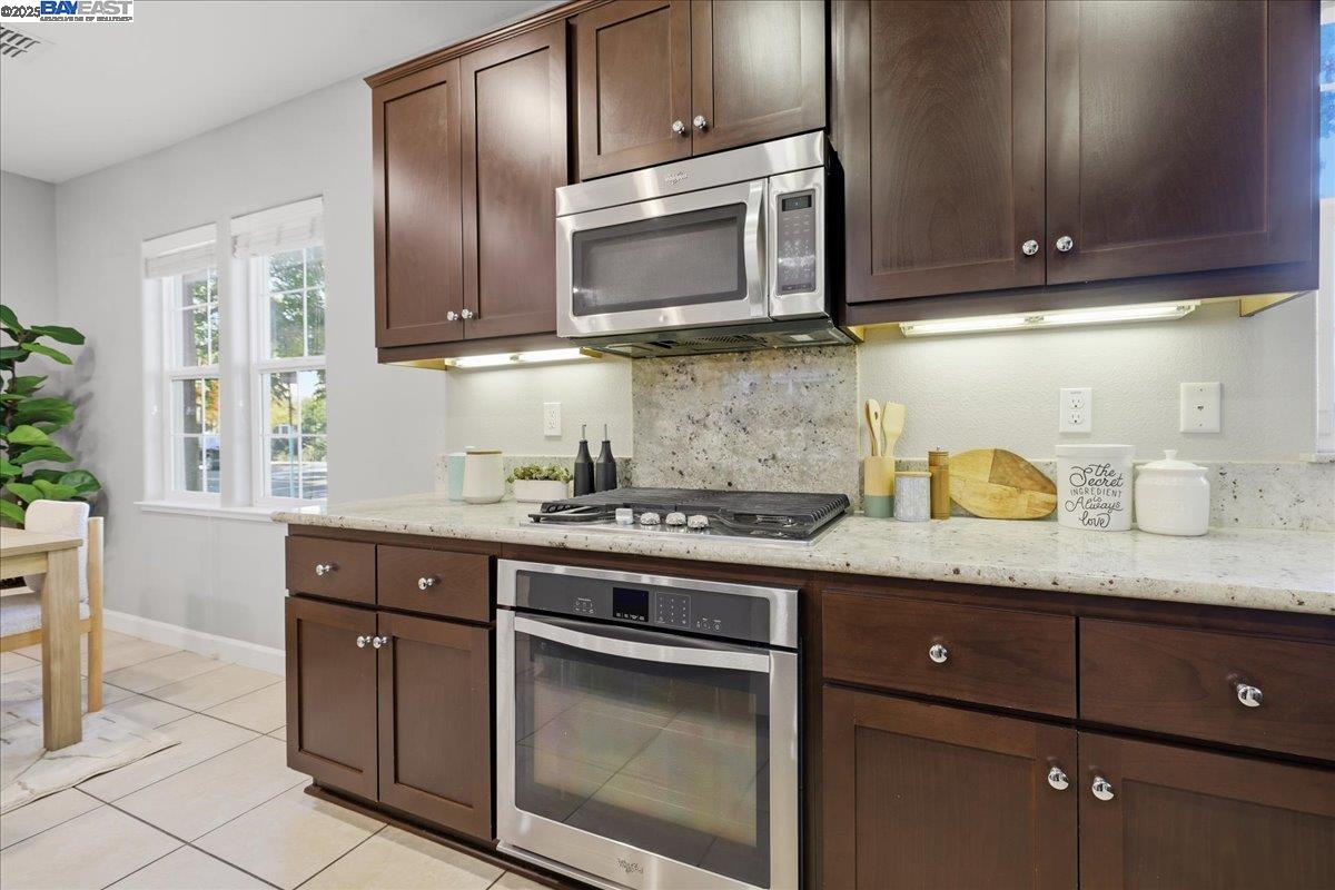 1504 Middle Lane Hayward, CA 94545 - Photo 23 of 60 a kitchen with granite countertop stainless steel appliances a stove a sink and a microwave