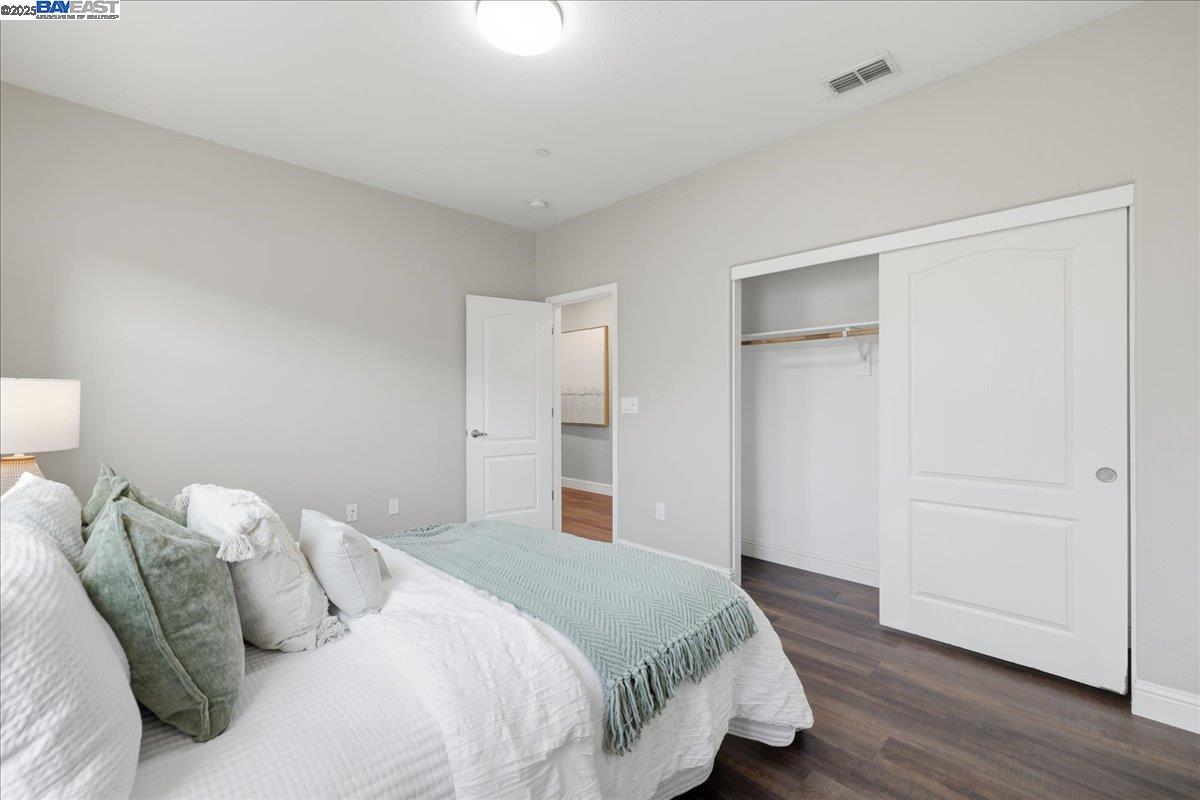 1504 Middle Lane Hayward, CA 94545 - Photo 33 of 60 a bedroom with a bed and wooden floor