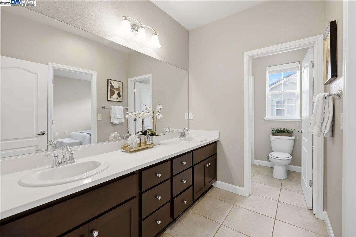 1504 Middle Lane Hayward, CA 94545 - Photo 34 of 60 a bathroom with a granite countertop sink a toilet and a mirror