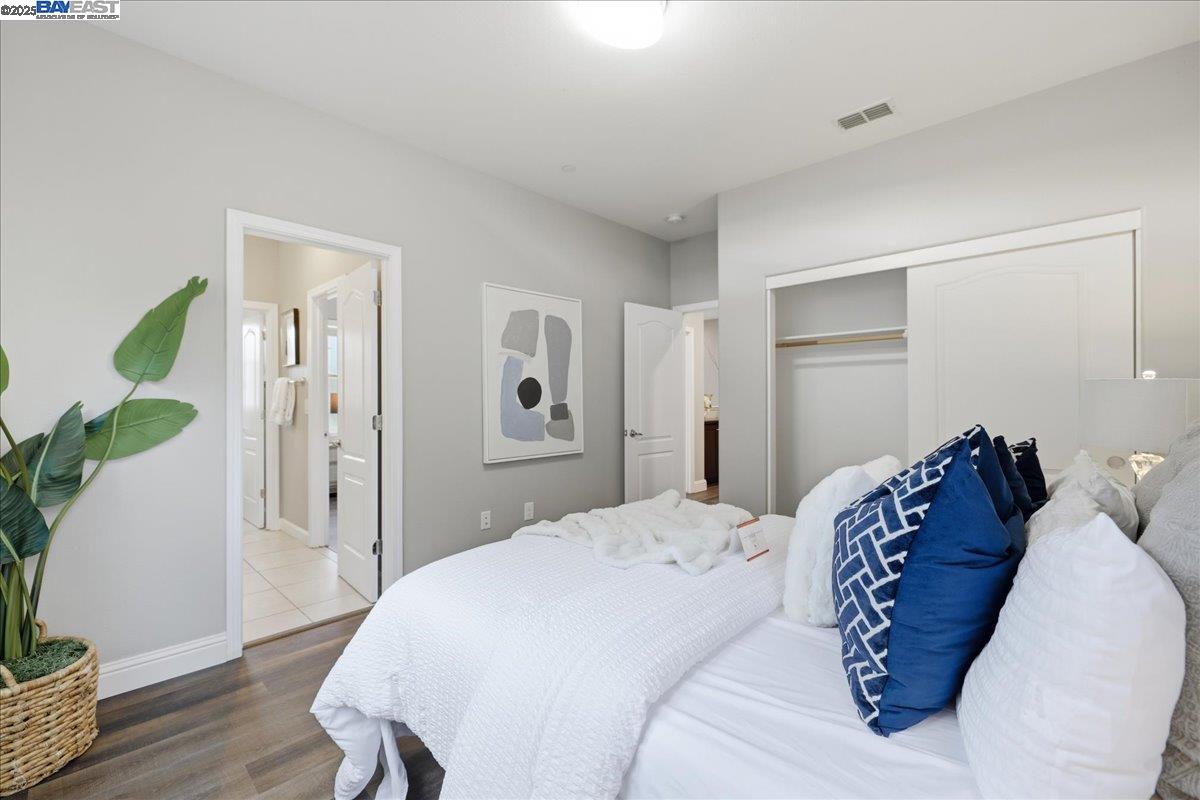 1504 Middle Lane Hayward, CA 94545 - Photo 39 of 60 a bedroom with a bed and a wooden floor