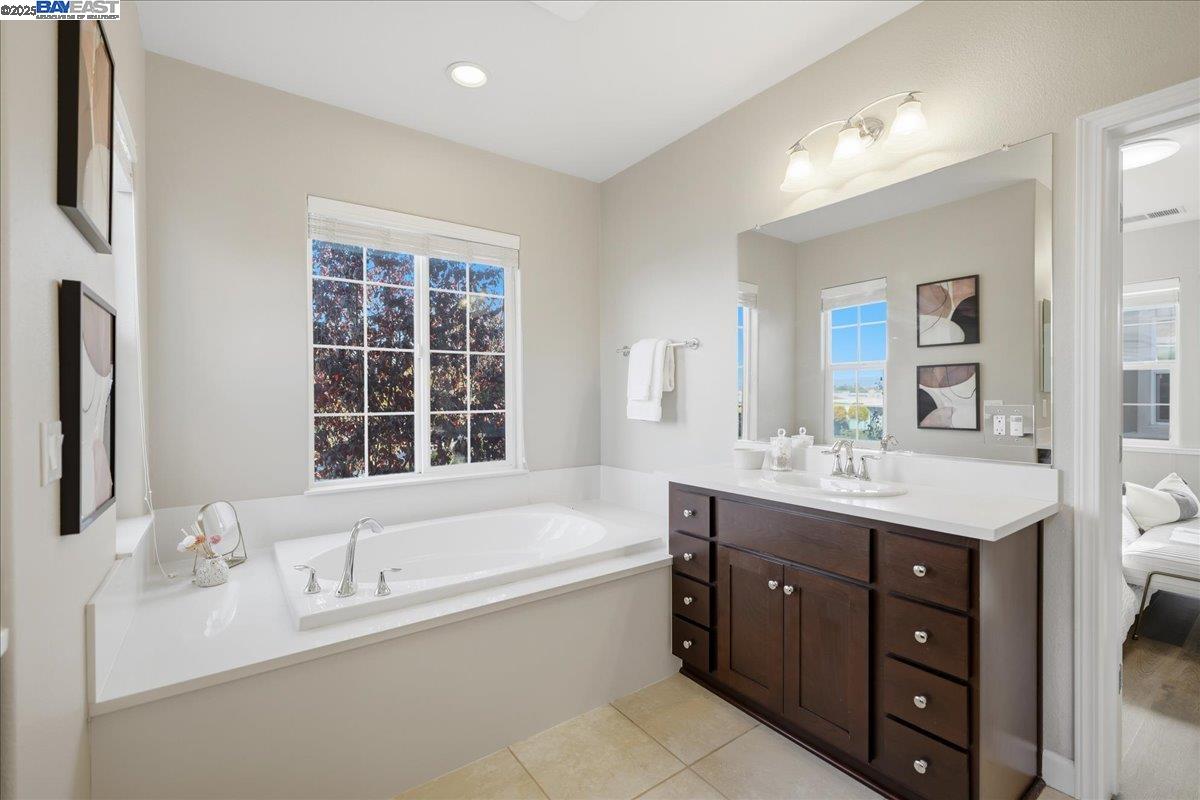 1504 Middle Lane Hayward, CA 94545 - Photo 48 of 60 a bathroom with a granite countertop double vanity sink a mirror and a bathtub