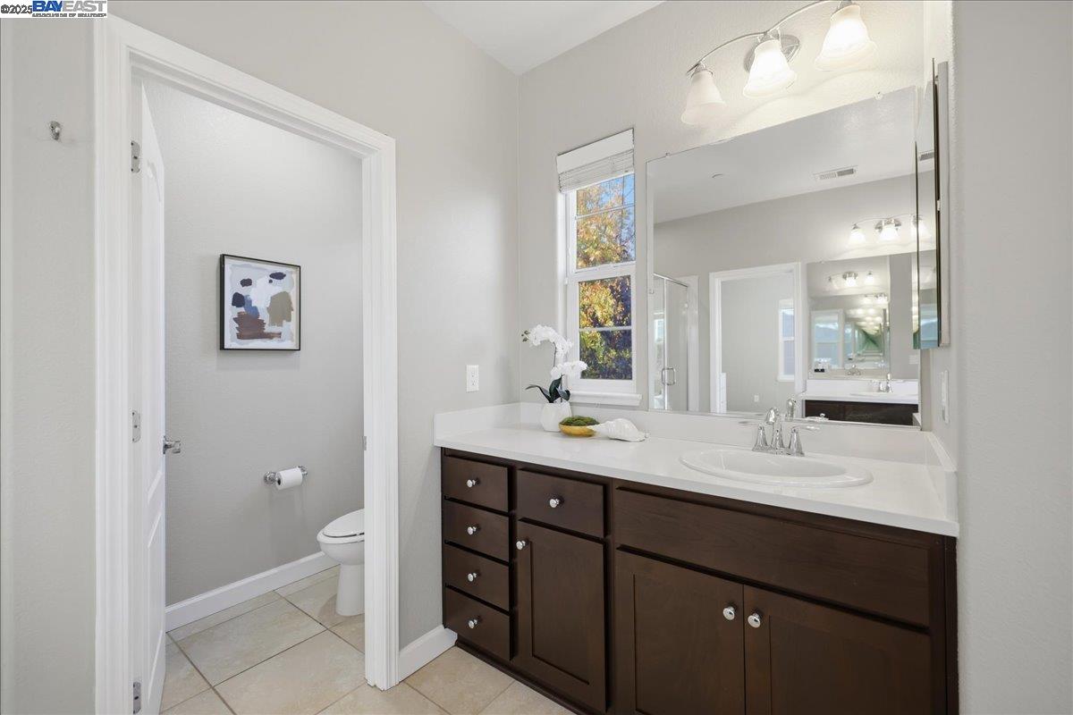1504 Middle Lane Hayward, CA 94545 - Photo 50 of 60 a bathroom with a granite countertop sink toilet and a mirror