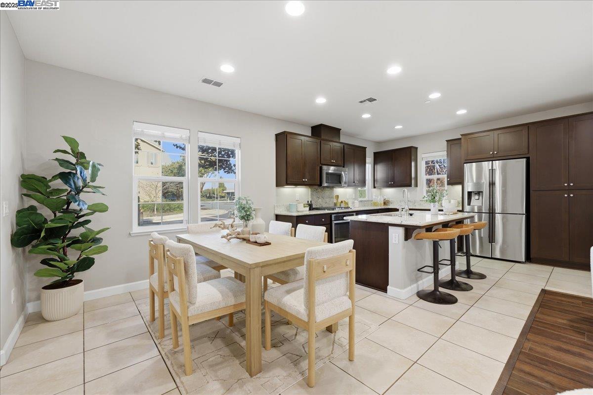 1504 Middle Lane Hayward, CA 94545 - Photo 9 of 60 a kitchen with a refrigerator and a dining table
