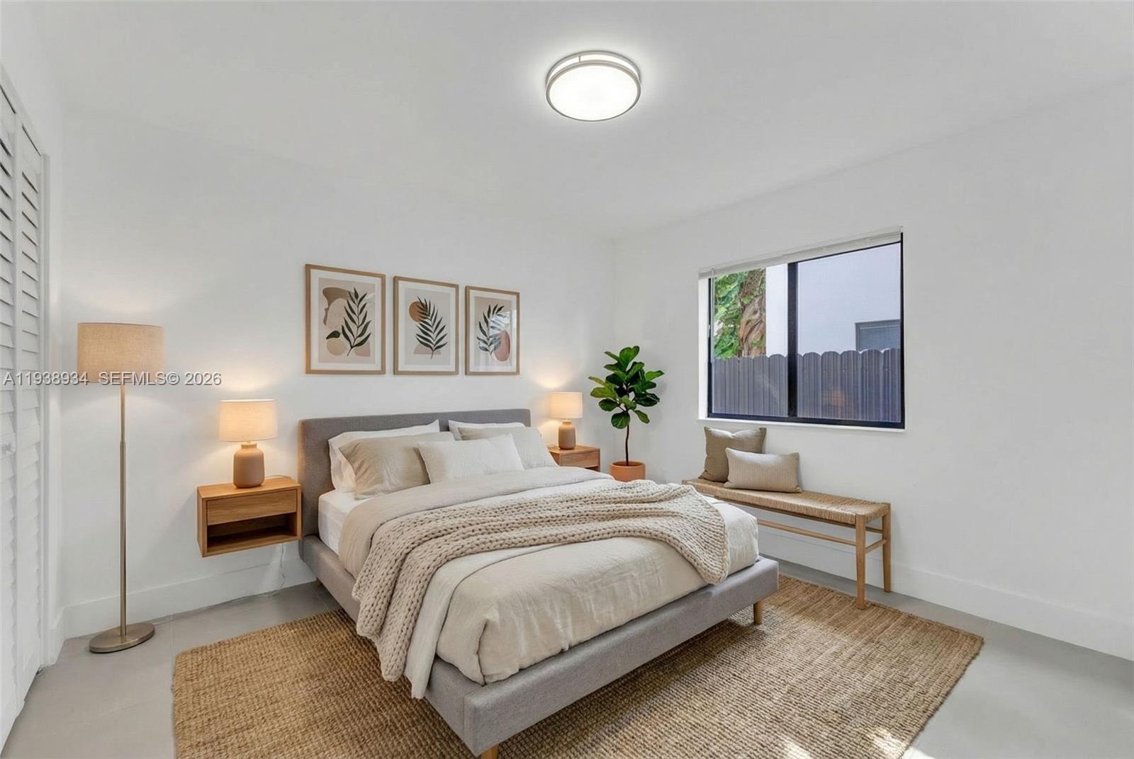 5821 Northwest 30th Avenue Miami, FL 33142 - Photo 5 of 14 a bedroom with a bed and a night stand